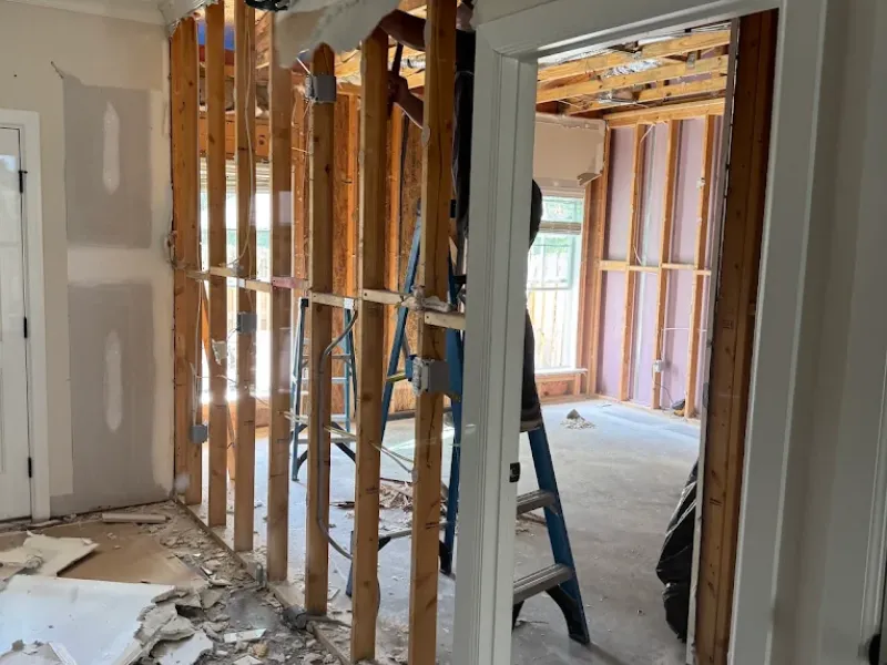 Interior home renovation with exposed wall studs and a ladder.